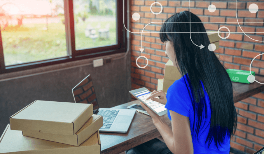 Woman at desk looking at mobile tablet