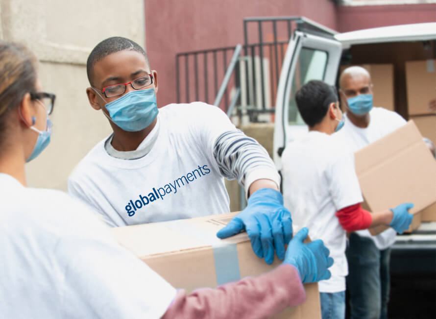 Group of people loading boxes into a van