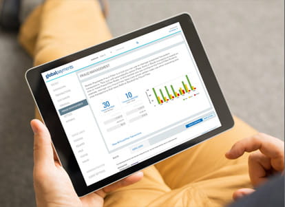User on tablet viewing Global Payments Fraud Management software