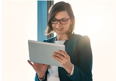 Woman smiling using tablet