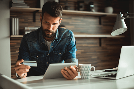 Man paying for item with tablet and card