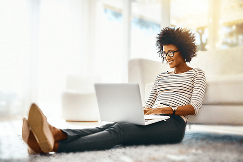 Woman sitting and using laptop
