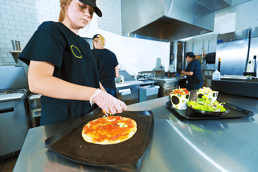 Person cutting pizza