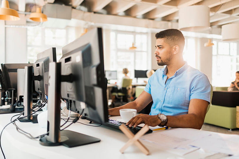 Man in modern office environment working at computer