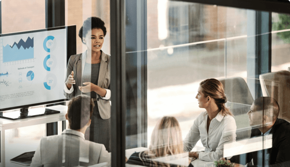 Woman in conference room standing and giving presentation
