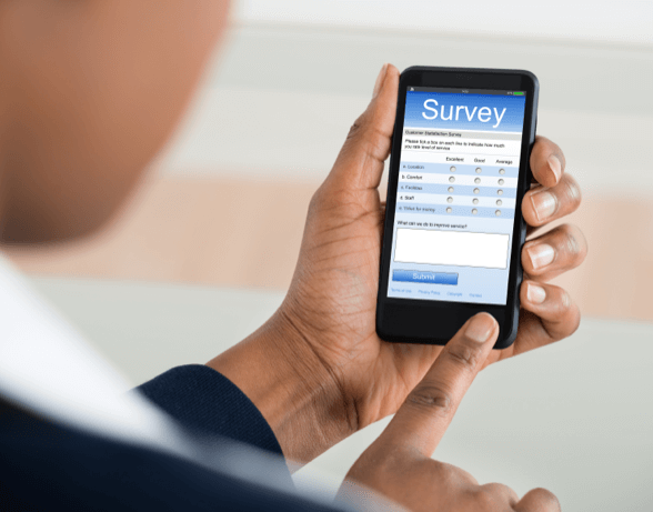 Closeup of man using mobile phone to take a survey