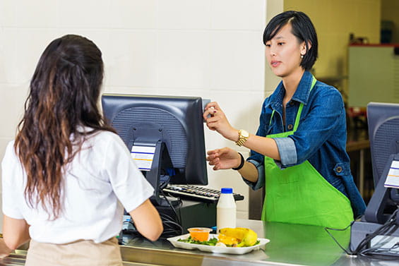 Woman paying at POS to female clerk
